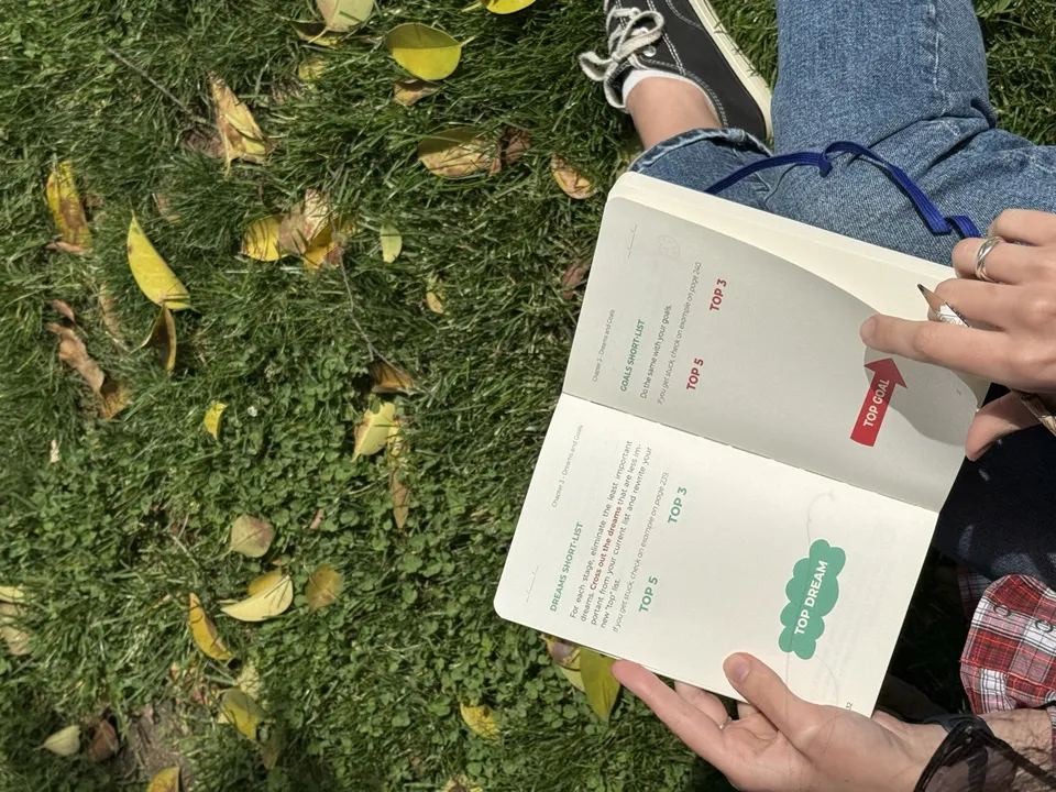 Reading the planner outdoors on grass